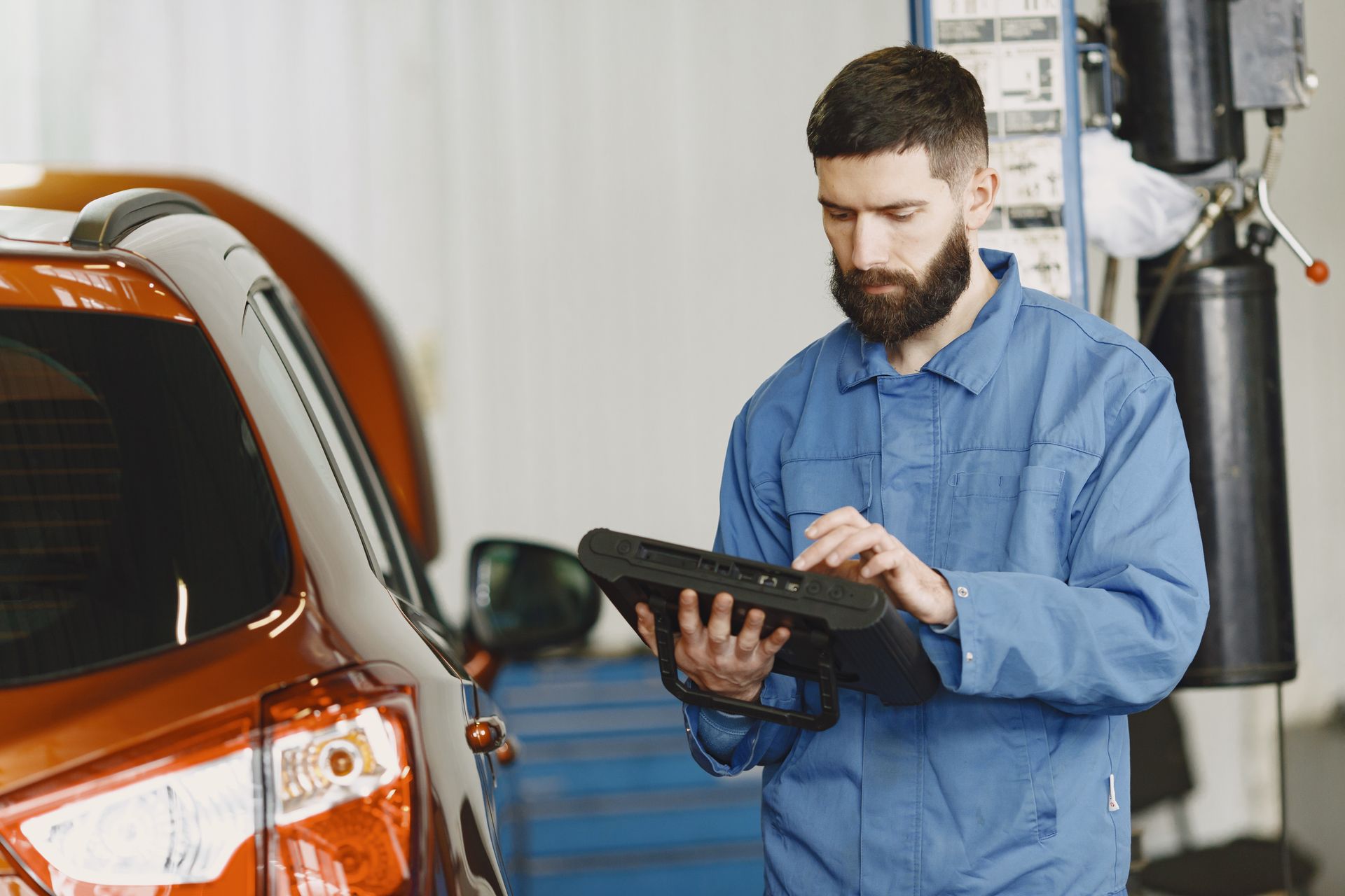 Technician using an automotive diagnostic scanner