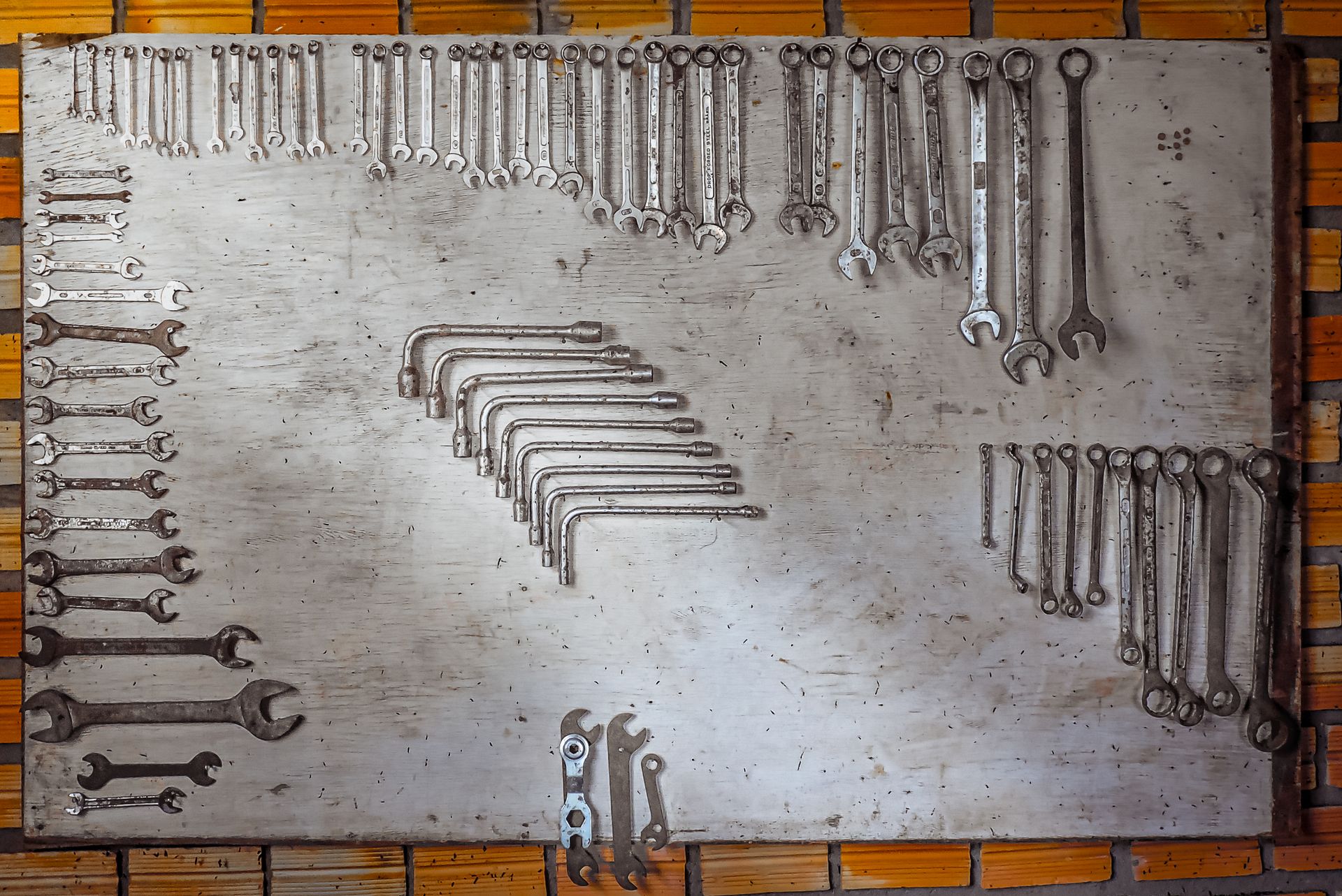 Wrenches arranged on a workshop tool board